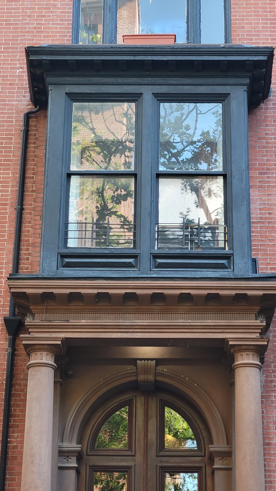 The bay above the parlor door, seen from the sidewalk
